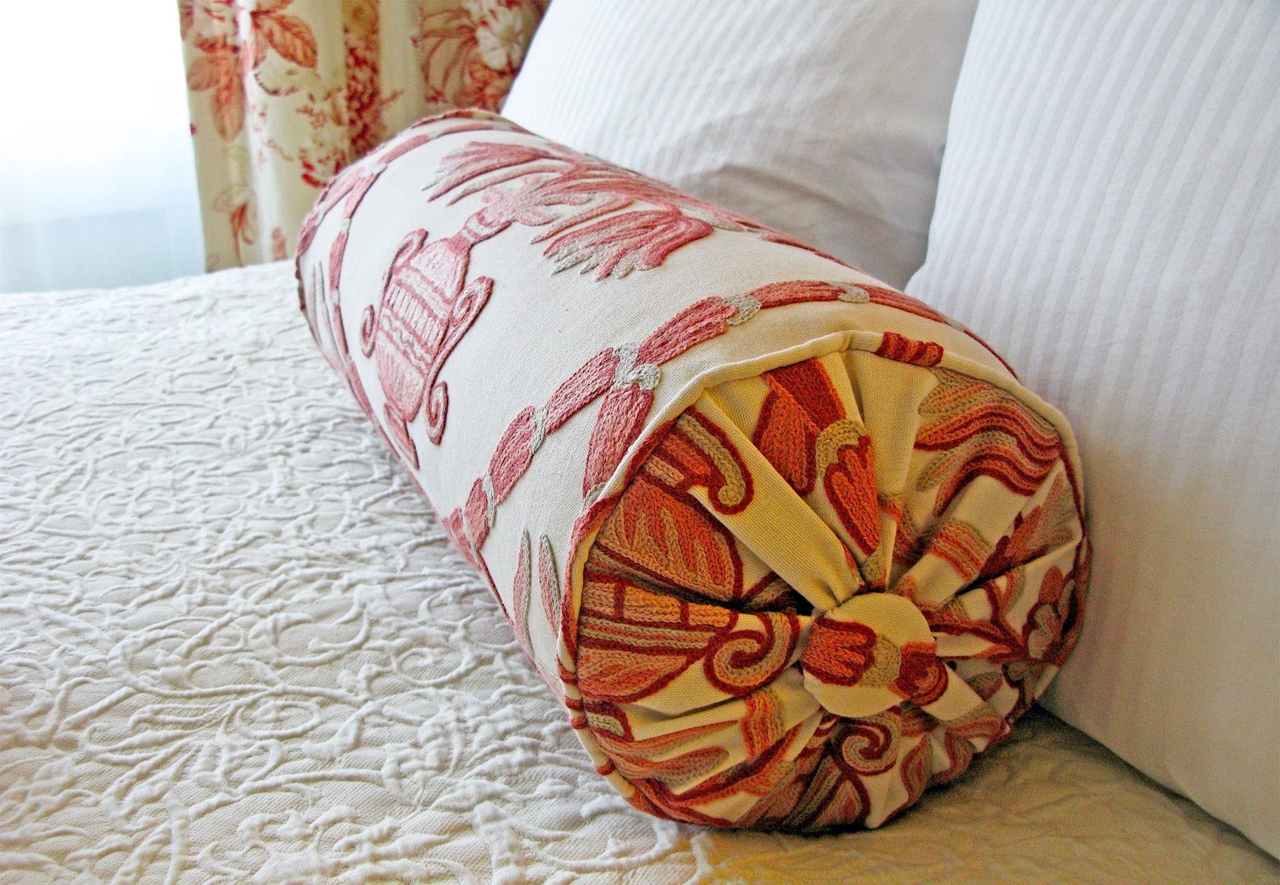 Hotel room bed and pillows.