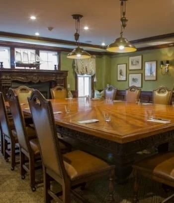 Elegant meeting room with large wooden table.