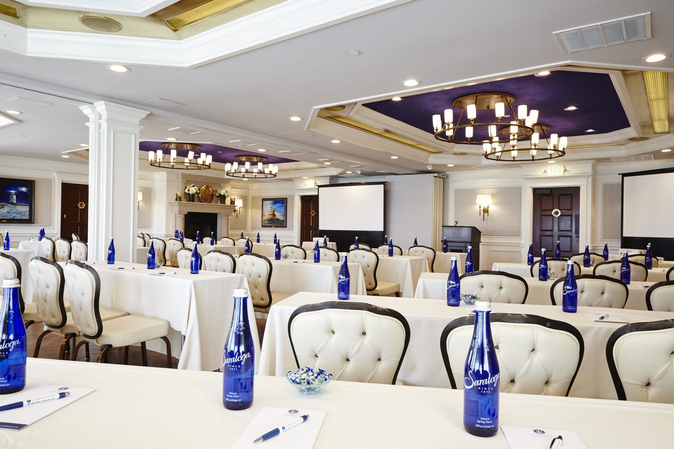 Meeting hall setup with tables and chairs.