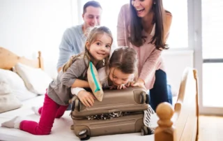 Photo of a Family Packing. Click Here to Learn How to Travel with Kids