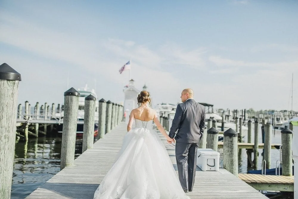 Bride and Groom walk on the docks in Old Saybrook, CT.